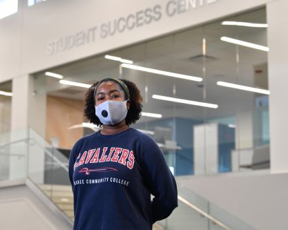 Student in Library with Cavaliers sweatshirt