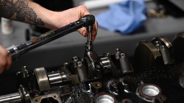 Automotive student working on a car