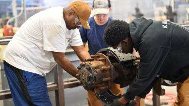 Students working on examining diesel parts