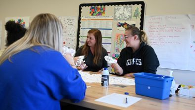 Early childhood education students working with whipping cream