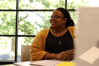 Coordinator of EDI (Equity, Diversity, and Inclusion) sitting down with a student. 