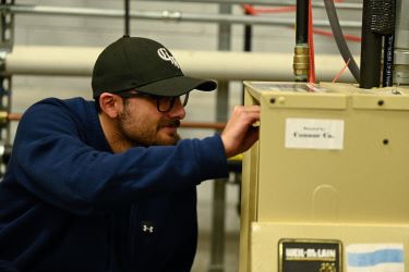 Air-Conditioning student checking out electrical output.