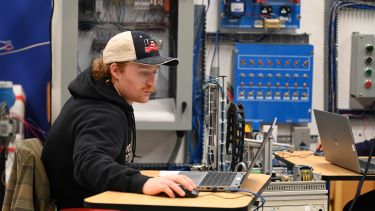 A student studying technical features on his computer