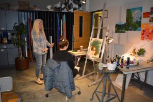  Art Professor Slowik and her student examining a piece a student has created. 