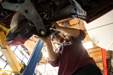 An automotive student fixing up his vehicle. 