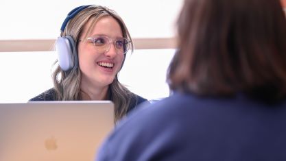 A student listening to some form of audio with her headphones on