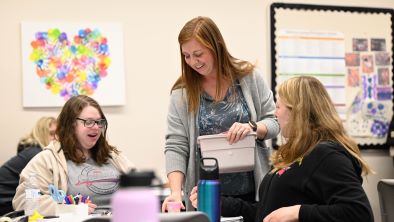 Early childhood education instructor Sarah Gowler communicating with two students