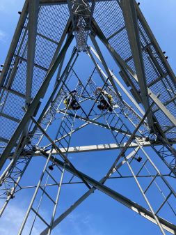 Electrical Engineering Wind Class with two engineering students climbing on a tower. 