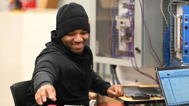 Electrical engineering student studying on his laptop