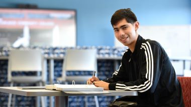 A student studying in the commons room in L355