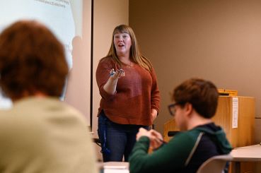 Communication professor giving a lecture. 